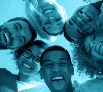 Group of people looking down at camera smiling